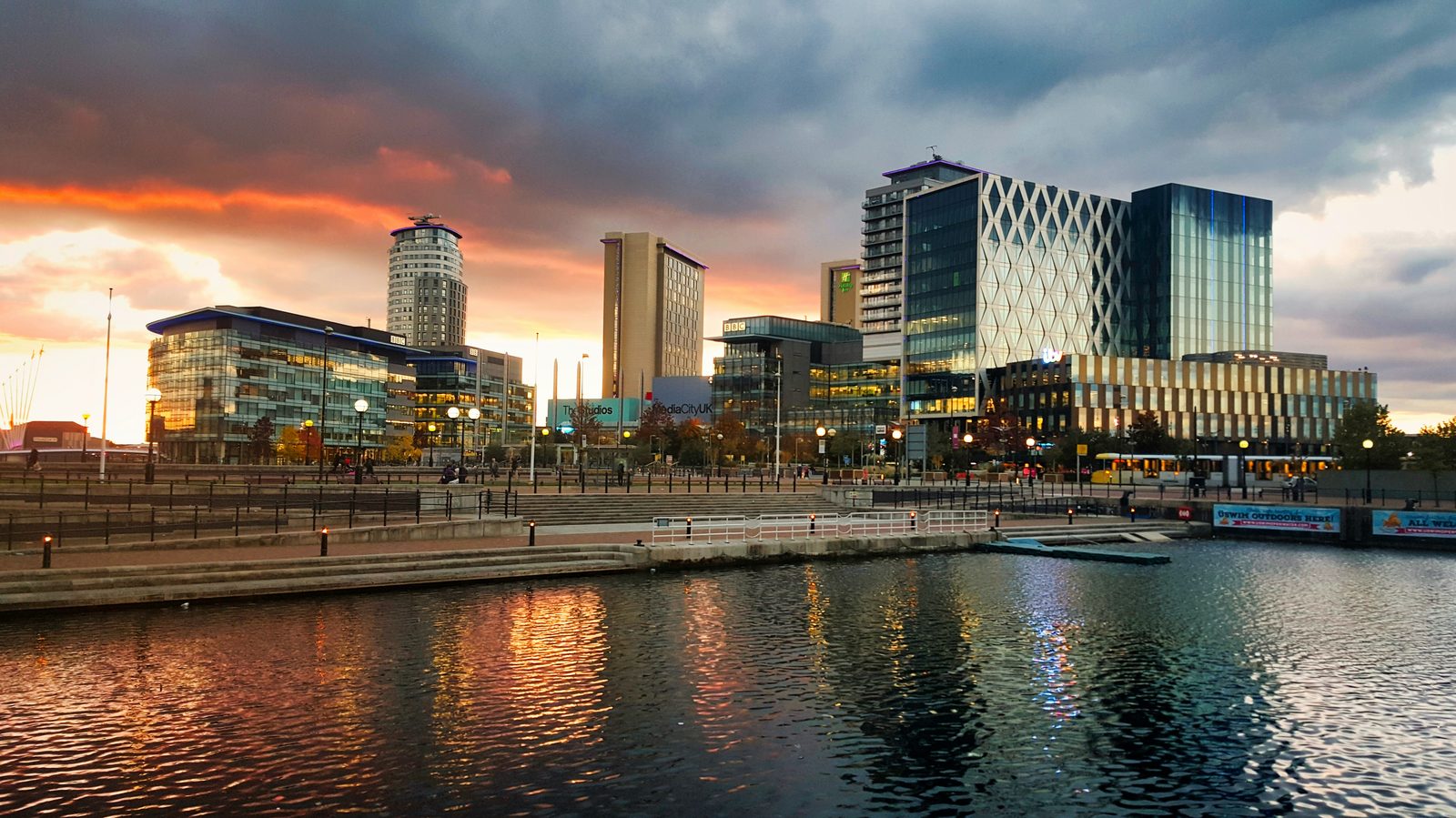Salford Quays in Manchester at sunset with reflections on the water